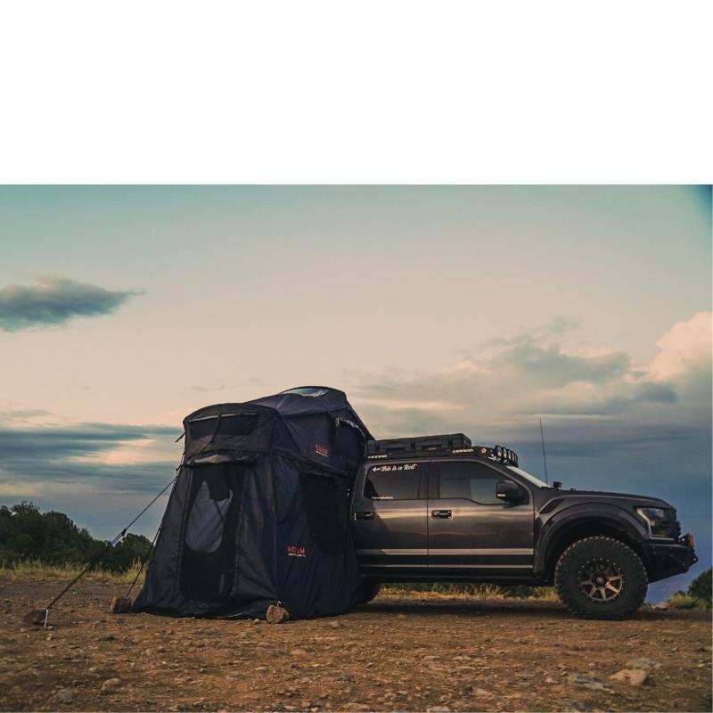 roam-vagabond-xl-rooftop-tent-black-open-front-corner-view-on-ford-ranger-with-annex-in-nature