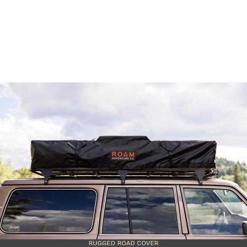 roam-vagabond-xl-rooftop-tent-closed-front-view-on-toyota-land-cruiser-with-rugged-cover-in-nature