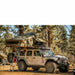 roam-vagabond-xl-rooftop-tent-forest-green-hyper-orange-open-front-corner-view-on-jeep-wrangler-rubicon-in-nature