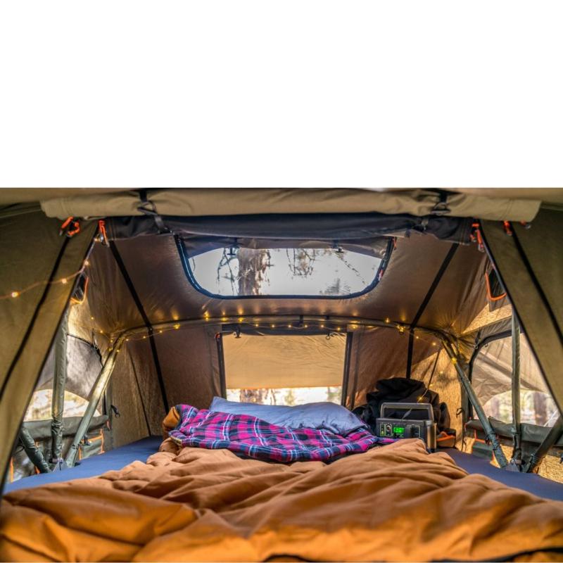 roam-vagabond-xl-rooftop-tent-forest-green-hyper-orange-open-interior-view-with-pillows-in-nature