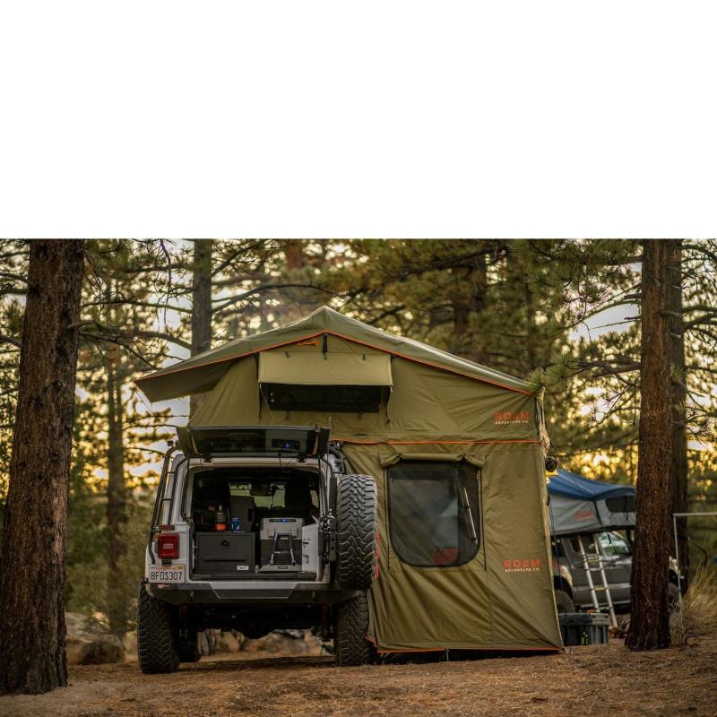roam-vagabond-xl-rooftop-tent-forest-green-hyper-orange-open-side-view-on-jeep-wrangler-in-nature