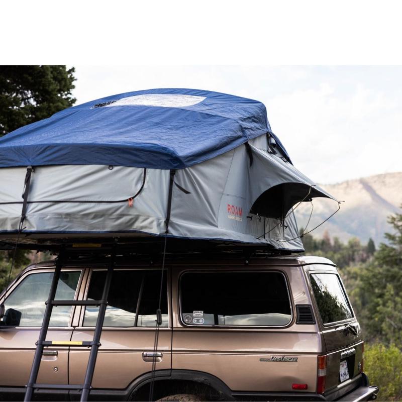 roam-vagabond-xl-rooftop-tent-slate-gray-navy-blue-open-close-up-view-on-toyota-land-cruiser-in-nature