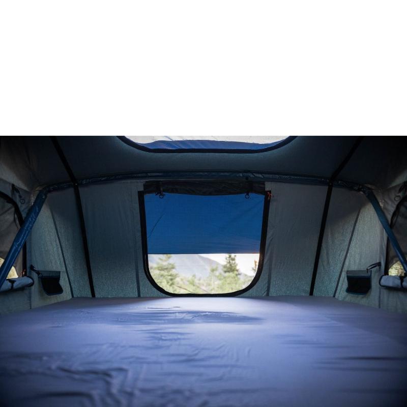 roam-vagabond-xl-rooftop-tent-slate-gray-navy-blue-open-interior-view-with-mattress-in-nature