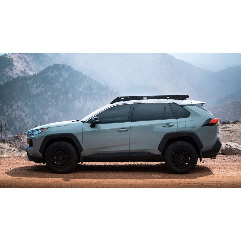 sherpa-snowmass-roof-rack-for-2019-2024-rav4-side-view-with-mountains-on-background-in-nature