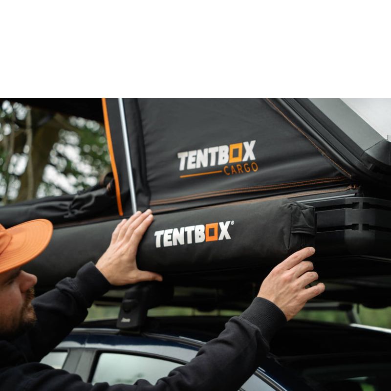tentbox-cargo-side-awning-closed-close-up-view-on-vehicle-with-person-opening-awning-bag-in-nature