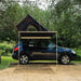 tentbox-cargo-side-awning-open-front-view-on-nissan-qashqai-with-rooftop-tent-in-nature