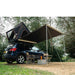 tentbox-cargo-side-awning-open-side-view-on-nissan-qashqai-with-chairs-in-nature