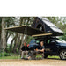 tentbox-cargo-side-awning-open-side-view-on-nissan-qashqai-with-persons-sitting-underneath-the-awning-in-nature