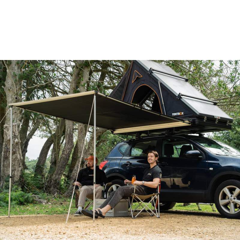 tentbox-cargo-side-awning-open-side-view-on-nissan-qashqai-with-persons-sitting-underneath-the-awning-in-nature