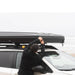 tentbox-classic-2-hard-shell-roof-top-tent-closed-side-view-on-vehicle-with-person-at-the-beach