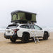 tentbox-classic-2-hard-shell-roof-top-tent-forest-green-open-front-corner-view-with-ladder-at-the-beach