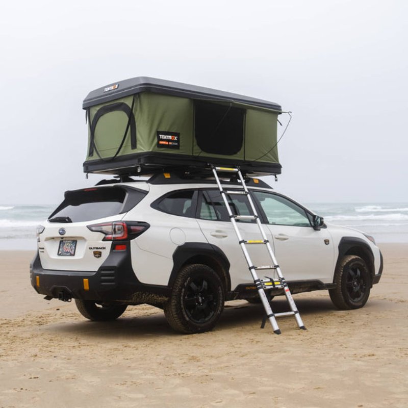 tentbox-classic-2-hard-shell-roof-top-tent-forest-green-open-front-corner-view-with-ladder-at-the-beach