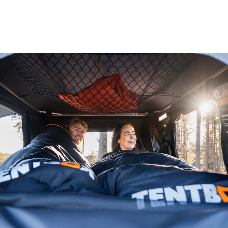 tentbox-classic-2-hard-shell-roof-top-tent-midnight-gray-open-interior-view-with-couple-inside-in-nature