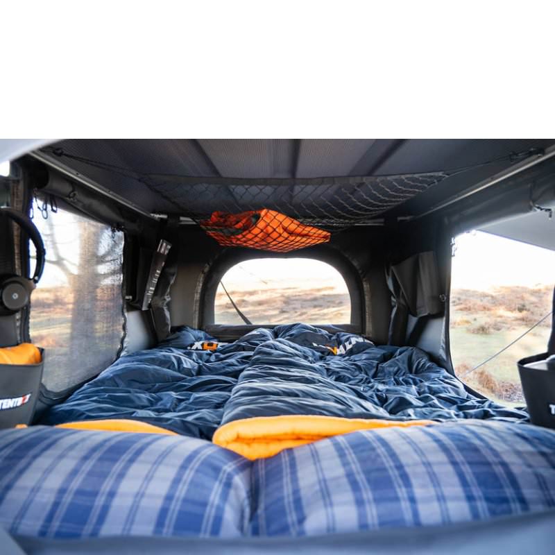 tentbox-classic-2-hard-shell-roof-top-tent-midnight-gray-open-interior-view-with-pillow-and-mattress-in-terrain