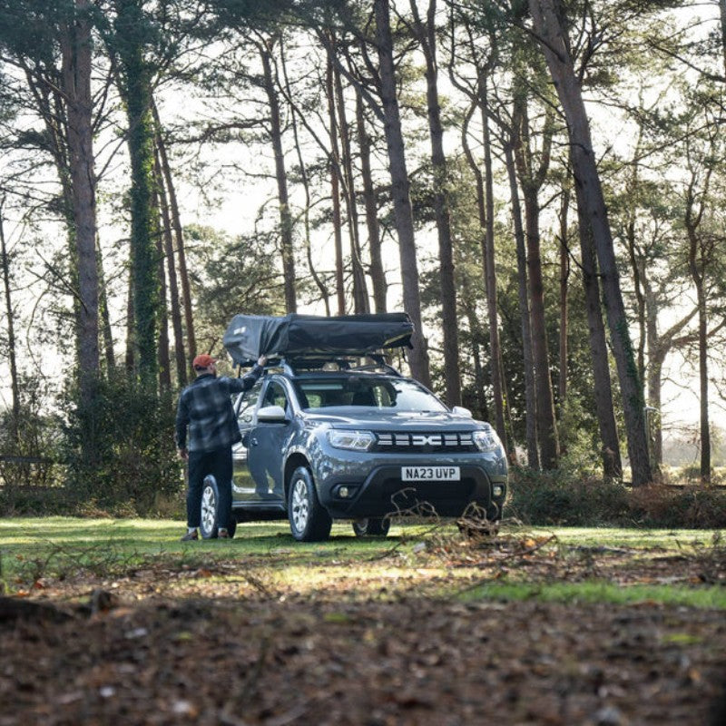 tentbox-go-hybrid-roof-top-tent-black-closed-rear-view-on-vehicle-with-man-in-nature