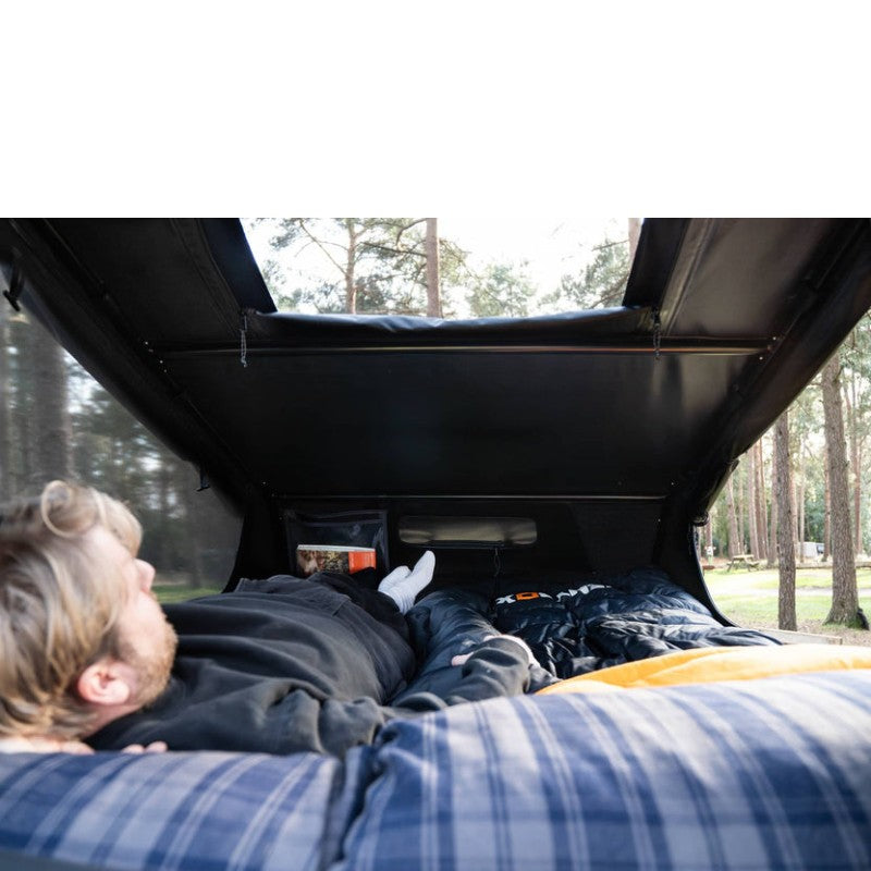 tentbox-go-hybrid-roof-top-tent-black-open-interior-view-with-man-resting-in-nature