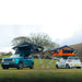 tentbox-lite-1-0-soft-shell-roof-top-tent-black-and-orange-open-side-view-on-jeep-and-hyundai-with-ladders-in-nature