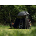 tentbox-lite-2-living-pod-black-wing-mode-open-front-corner-view-with-telescopic-poles-on-fiat-panda-cross-in-nature