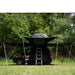tentbox-lite-2-living-pod-black-wing-mode-open-front-view-with-telescopic-poles-and-ladder-on-fiat-panda-cross-in-nature