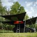 tentbox-lite-xl-living-pod-black-wing-mode-open-interior-view-with-telescopic-poles-on-vehicle-in-nature
