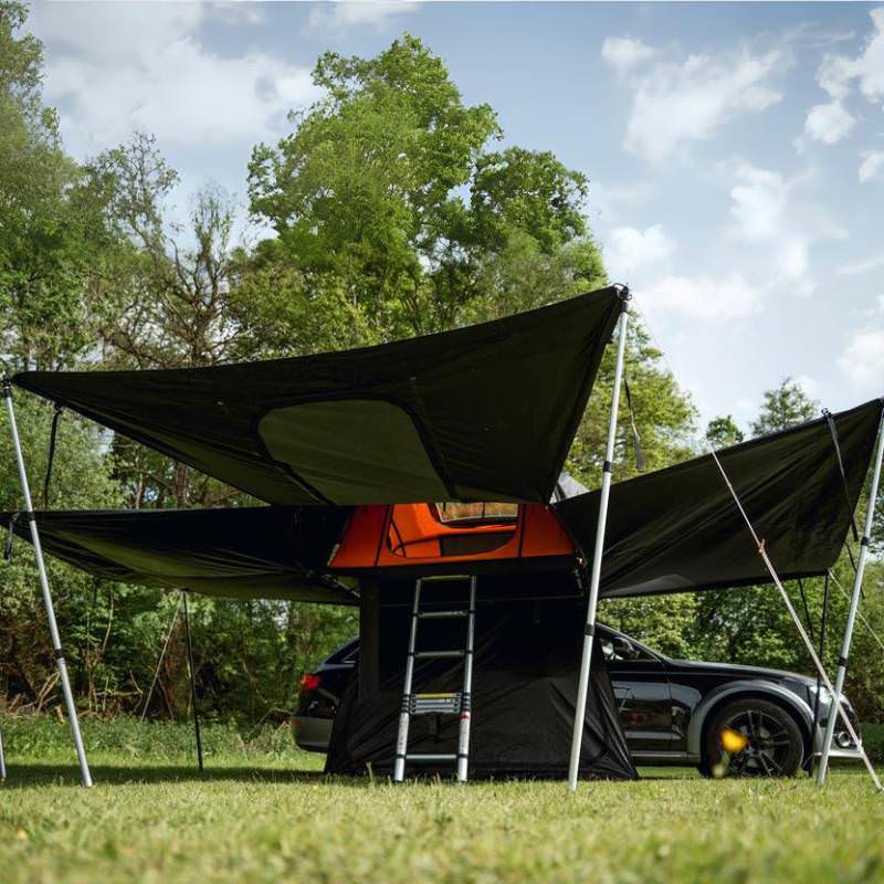 tentbox-lite-xl-living-pod-black-wing-mode-open-interior-view-with-telescopic-poles-on-vehicle-in-nature