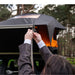 tentbox-universal-side-awning-open-close-up-view-on-vehicle-with-person-holding-rope-in-nature