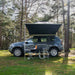 tentbox-universal-side-awning-open-front-view-on-dacia-duster-with-chairs-in-nature