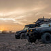 overland-vehicle-systems-nomadic-standard-soft-shell-roof-top-tent-grey-open-side-view-on-Jeep_Gladiator-in-desert